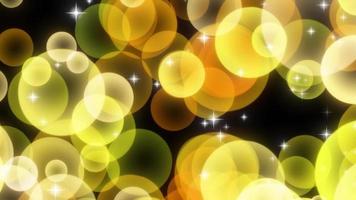 Yellow sparkly circular particles rising video