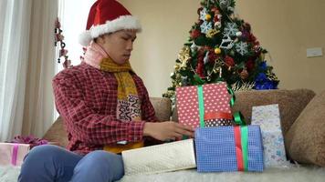apuesto joven abriendo su regalo de navidad video