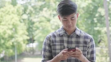 Young man using mobile phone video