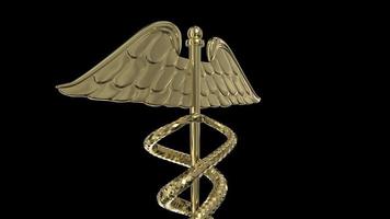 en gyllene caduceus medicinsk symbol roterar på en svart bakgrund video