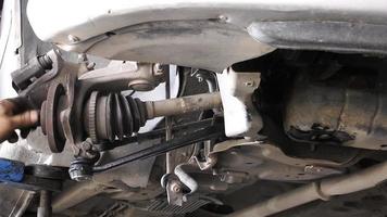 Mechanic Repairs The Undercarriage Suspension And Axle Parts Of A Car video