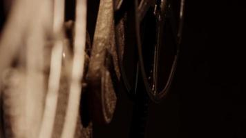 Close up of 8mm movie projector, showing two film reels focusing just one in background in 4K video