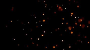 Several groups of fire embers flying on darkness in 4K video