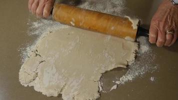 Woman using a rolling pin to roll out dough | Free Stock Footage