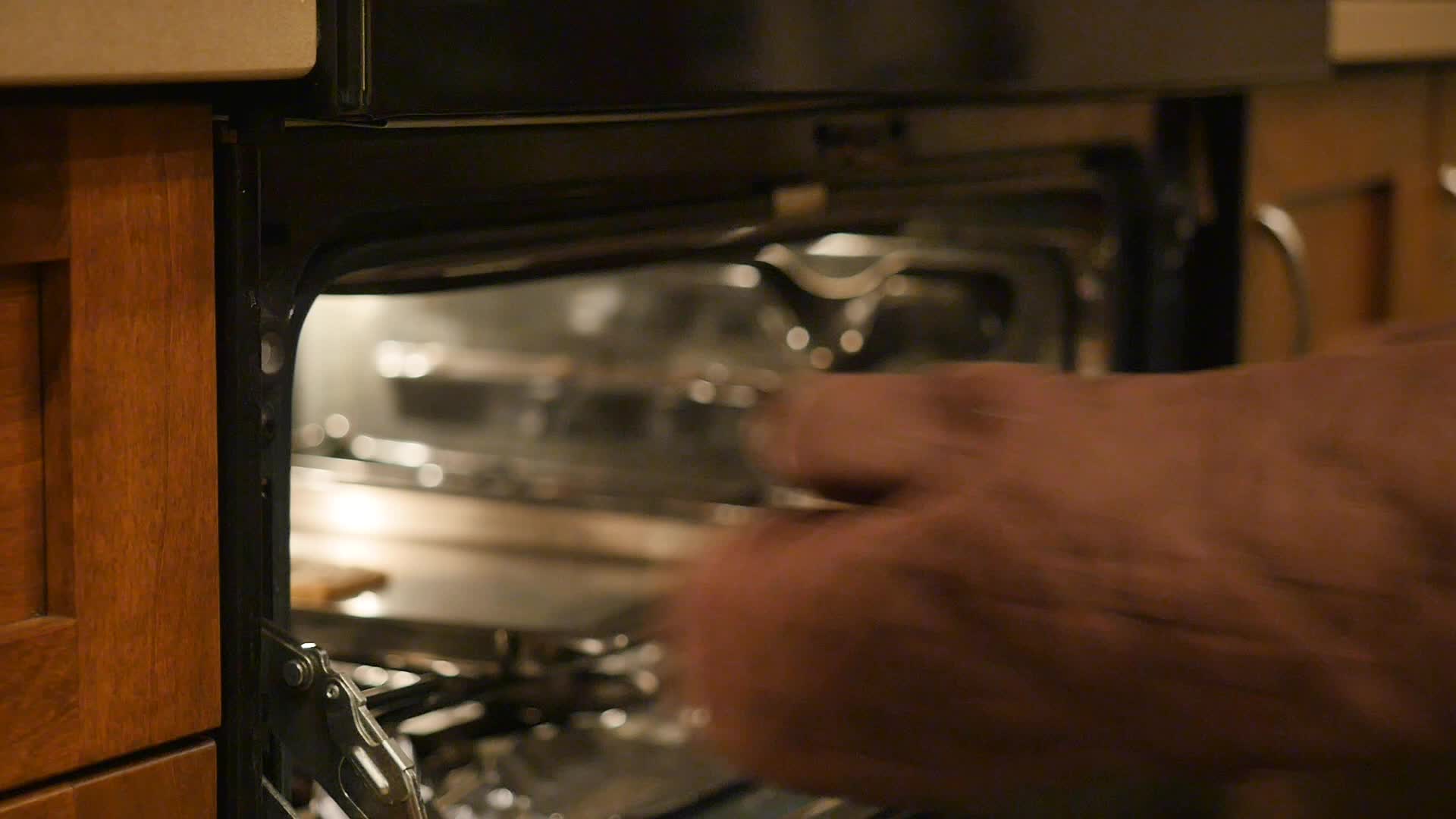 Woman pulling pan out of oven Free Stock Footage 1798997 Stock Video