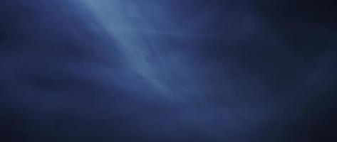 Transparent smoke floating with soft movements on dark background in 4K video