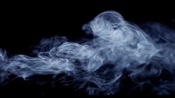 Close up of smoke with horizontal path and beautiful waves on dark background in 4K video