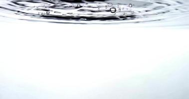  Nine groups of drops falling and splashing on a clear water container in 4K video