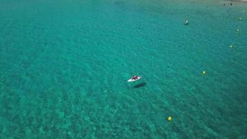 Flying over a paddle board in the bay in 4K video