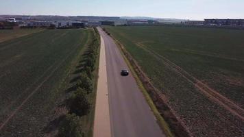 Drone follows a sports car from back in 4K video