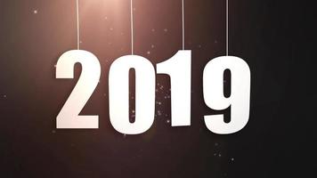 Happy New Year 2019 white paper numbers hanging on strings falling down black background video