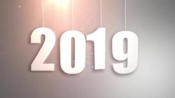 Happy New Year 2019 white paper numbers hanging on strings falling down white background video