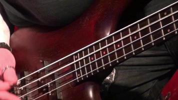 bass guitar in live action at a concert - rack focus - close up