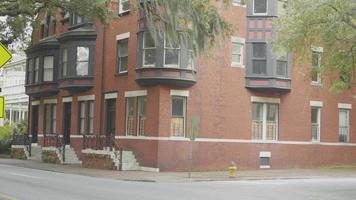 Handheld Clip Of Brick Building With Cars In Foreground video