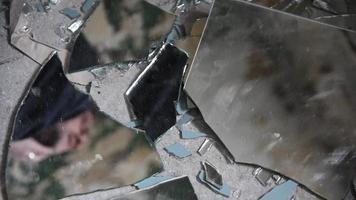 Depressed and angry man looks in broken glass shards video