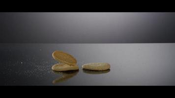 Falling cookies from above onto a reflective surface - COOKIES 182 video