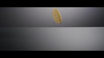 Falling cookies from above onto a reflective surface - COOKIES 180 video