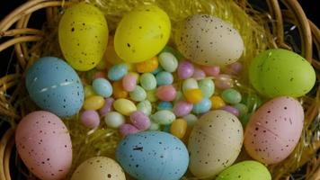 Rotating shot of Easter decorations and candy in colorful Easter grass - EASTER 055 video