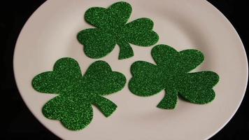 Rotating stock footage shot of St Patty's Day clovers on a white surface - ST PATTYS 004