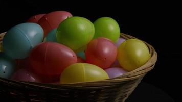 Rotating shot of Easter decorations and candy in colorful Easter grass - EASTER 032 video
