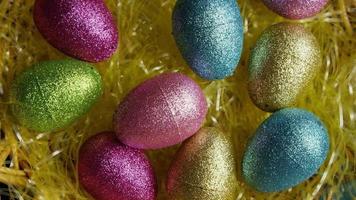 Rotating shot of Easter decorations and candy in colorful Easter grass - EASTER 011 video