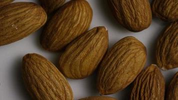 Cinematic, rotating shot of almonds on a white surface - ALMONDS 004 video