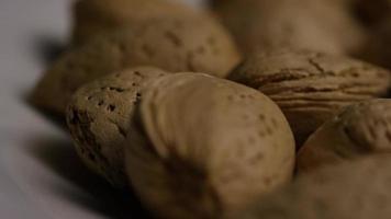 Cinematic, rotating shot of almonds on a white surface - ALMONDS 103 video