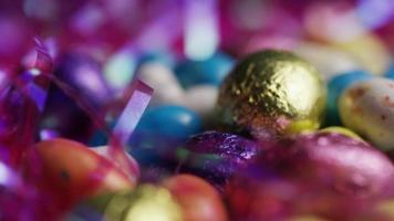 Rotating shot of colorful Easter candies on a bed of easter grass - EASTER 187 video
