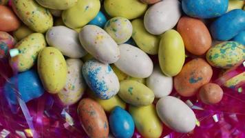 Rotating shot of colorful Easter candies on a bed of easter grass - EASTER 115 video