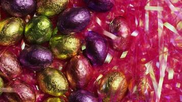 Rotating shot of colorful Easter candies on a bed of easter grass - EASTER 202 video