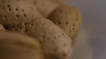 Cinematic, rotating shot of almonds on a white surface - ALMONDS 105 video