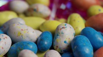 Rotating shot of colorful Easter candies on a bed of easter grass - EASTER 131