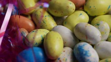 Rotating shot of colorful Easter candies on a bed of easter grass - EASTER 128