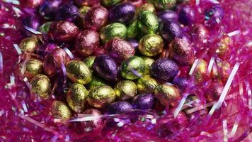 Rotating shot of colorful Easter candies on a bed of easter grass - EASTER 235 video