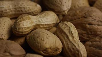 Cinematic, rotating shot of a variety of nuts on a white surface - NUTS MIXED 022 video