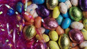 Rotating shot of colorful Easter candies on a bed of easter grass - EASTER 161 video