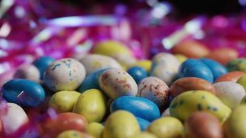 Rotating shot of colorful Easter candies on a bed of easter grass - EASTER 145 video