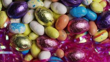 Rotating shot of colorful Easter candies on a bed of easter grass - EASTER 162