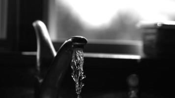 Water pouring from a faucet in ultra slow motion 1,500 fps on a reflective surface - WATER FAUCET 016 video