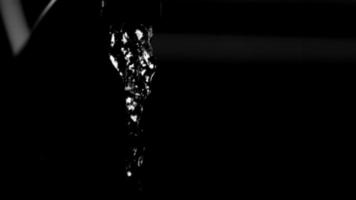 Water pouring from a faucet in ultra slow motion 1,500 fps on a reflective surface - WATER FAUCET 001 video