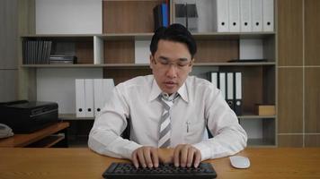 Businessman employee typing keyboard and looking at monitor computer video