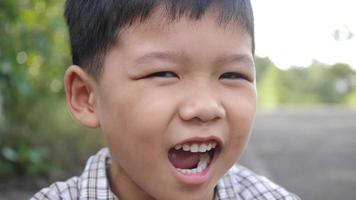 Close up little boy laughing and smile after hearing joke story video