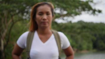 Portrait of woman traveler smiling in the nature video