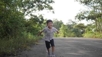 feliz niño asiático corriendo en la calle video