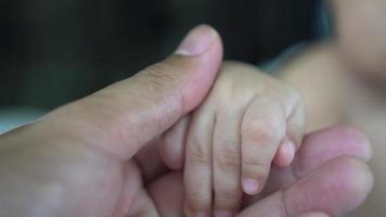 Motion of Child hand holding parent hand video