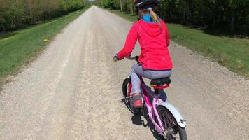 Camera follows a girl on bicycle in 4K video