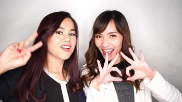 Two happy and attractive business women after completing a project video