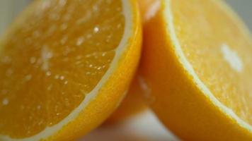 Spinning sliced orange on neutral background video