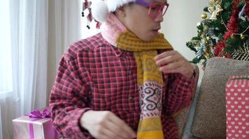 Handsome young man opening his Christmas gift video