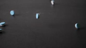 Slow-motion of Pills falling on a table video